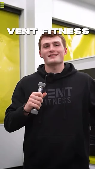 Vent Fitness video, trainer holding a dumbbell in the gym